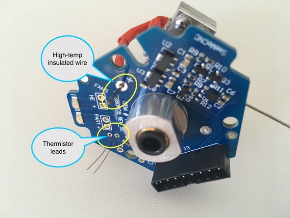 Feed the thermistor wires through the two holes just to the right of &quot;PART +&quot; (or the holes marked &quot;TEMP&quot;). See image for reference.