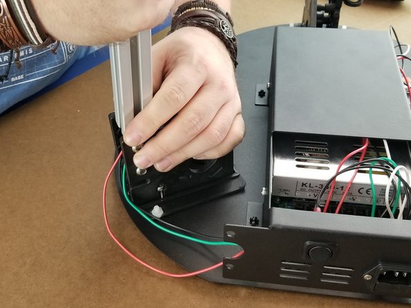 On the brackets closest the hole the wires are coming from the power supply at, you will insert the extrusion in the brackets.