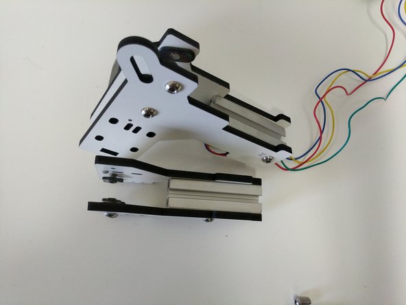 Slide the TSLOT into one side of the plates as shown. You can loosely tighten the button head screw to keep it held in place. Do not tighten.