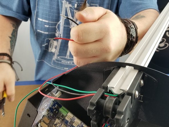 You will now be working with the red and black wires that are in the same tower as the green wire.