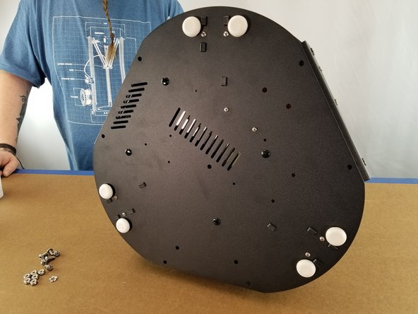 Turn the machine on the side so you have access to the power supply bracket panel and the bottom of the machine.