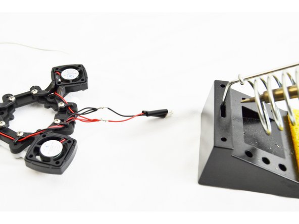 You will now perform an in-line splice soldered connection of the three bundled leads with the lead that has the plug installed. You will perform this type of splice for the red and black wires (separately) as shown in the images.