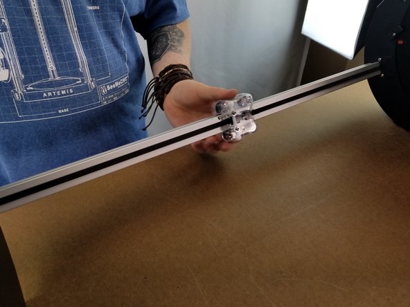 The carriage should be in place and attached to the belt at this point.  Slide the carriage up and down the tower to make sure the movement is free and smooth.