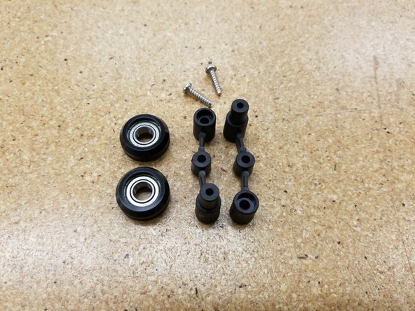 The newer style of spring arms use two identical arms and two screws for assembly.