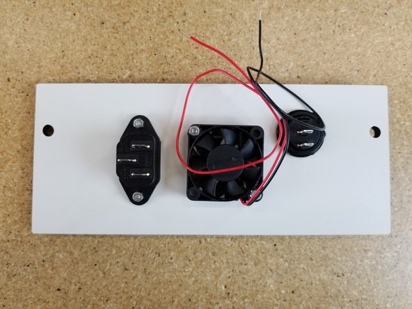 The IEC Plug is installed using (2) M3 x 14mm long screws and (2) Nylon Lock Nuts.