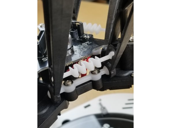 Install the ball cup arms and springs as seen here.