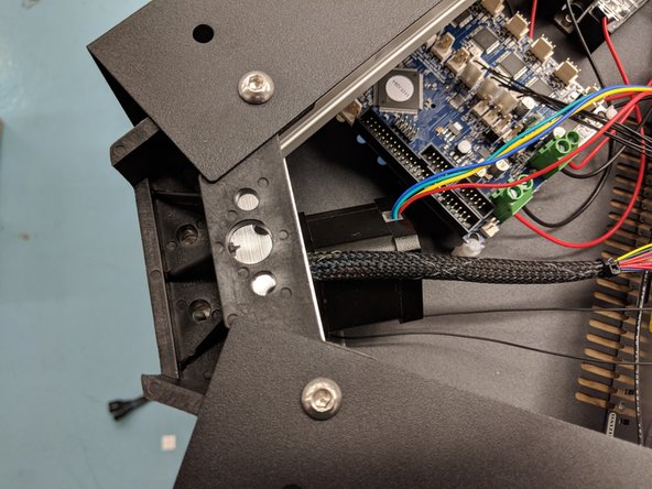 You will now lift the tower and slowly slide it into the upper assembly. The tower assembly will clear the limit switch. As you are sliding it into place you will need to ensure that the wires stay down in their relief, otherwise they will get pinched when tightening the plate.