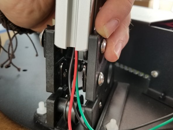 This is why the T-Nuts were left loose.  The T-nuts go inside the sides of the rail.  Make sure all 4 T-Nuts go inside the rail.  You may need to loosen the button head screws to get the T-Nuts in the extrusion.