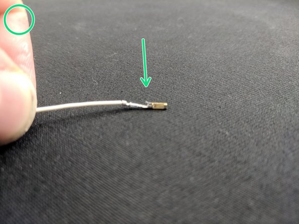 In the picture with the green circle the "Tab" on the SL connector is being highlighted. This tab is what latches in the "window" of the connector to prevent it from coming out. You must orient the wires correctly when inserting them or the wire will come out.