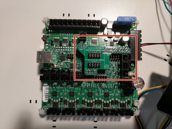 Locate and install the LCD adapter onto the RAMBo board in the position indicated. Ensure that you properly align the pins and headers of both components.