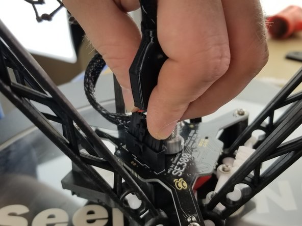 Insert the 10 pin harness into the hotend board and fully seat plug all the way and it will click and secure into place.