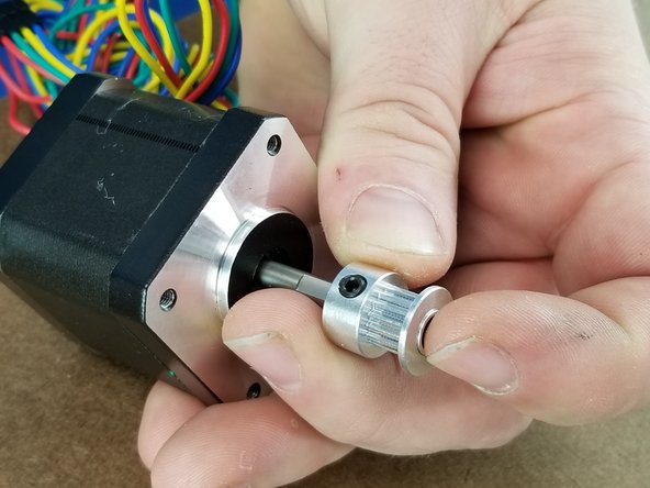 You will insert a pulley onto the motor as shown in Pic 2.  There is a flat section on the motor shaft, and you will line the set screw up with this flat so it is tightened onto the flat.