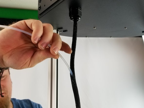 The covering is a mesh, so you will work the PTFE tube into the mesh with the wires.