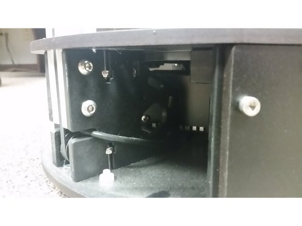 Remove the acrylic plates on the corners to get at the tower mount screws.