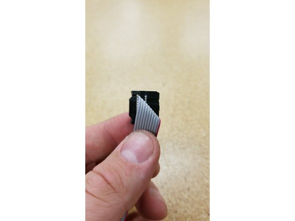 Hold the loose end of the ribbon cable and fold it exactly as shown in photos 1, 2, and 3.