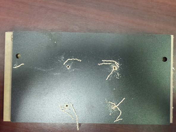 Using a #42 drill bit you should now drill holes in the 4 locations previously marked. Be sure to use a put a scrap piece under the side panel does not split out (and you don't drill through your table!)