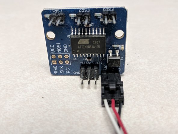 The JOHN SL board is already installed in the base with FSR wires connected at the factory. You'll be plugging in the white, red, and black connector as shown.