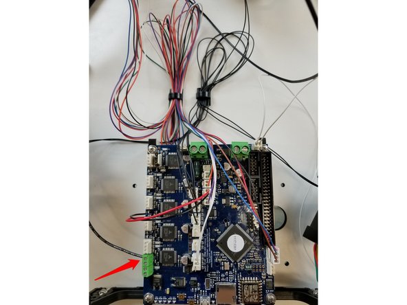 The black 20awg wire from the hotend whip can now be attached to the terminal block as indicated in the photo. You may need to rotate the screw counter clockwise before inserting the wire to open the terminal, as it may be closed from the factory.
