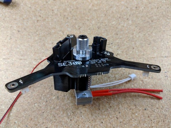 On the PTFE tube, one side is tapered.  This is the side that goes in the knurled finger screw and should be towards the top of the hot end.