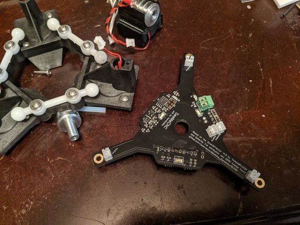 Unscrew the heater cartridge terminals as shown in Pic 1 with the GREEN arrows.   You should now be able to lift away the hotend and set it aside.
