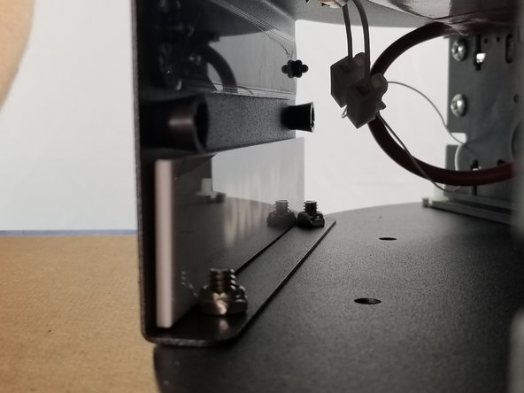 Line the white acrylic up behind the logo and press the double sided tape into the sheet metal to secure it in place.