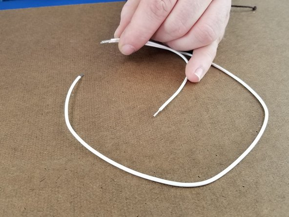 Combine the ends of the two wires together similarly to you did with the green wires.