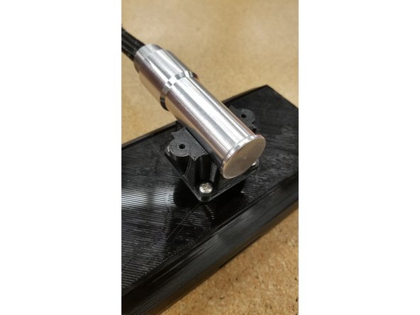 Pull out the slack in the cables between the saddle and the mounting post, and place the mounting post in the saddle.