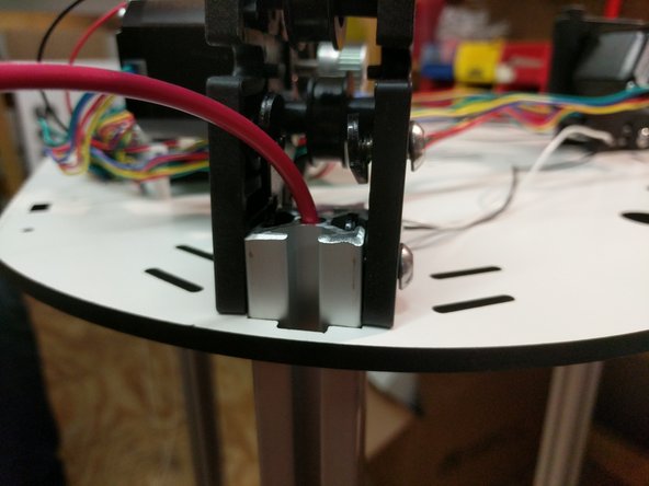 You will now need to work around the machine, one tower at a time aligning the TSLOT nut in a vertical orientation and slowly working down the top assembly. You will ultimately go around doing this process several time to work the top assembly down.