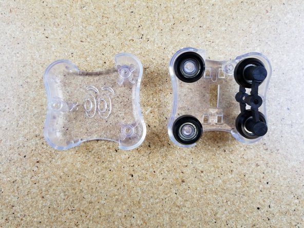 Install the outer carriage half. Ensure that the alignment pin in that carriage half inserts into the hole in the center of the spring arm.