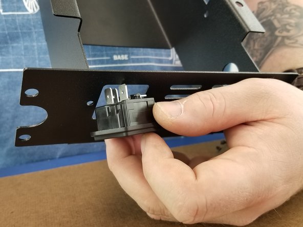 Insert the plug reciever with fuse holder into the power supply bracket from the outside of the bracket as shown in Pic 1.