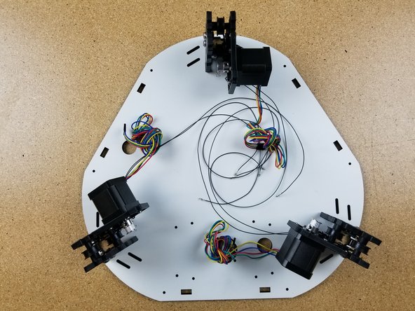 Install the timing pulleys on the motor shafts with the set screw up against the flat, as shown in the photo.