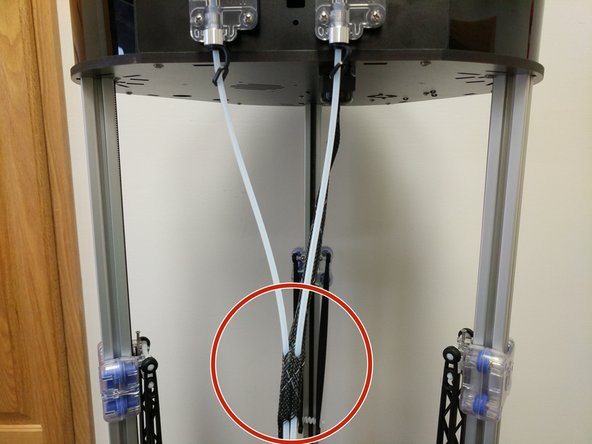 Route the bowden tubes down and run them through approximately 1-2&quot; of the mesh loom as shown.