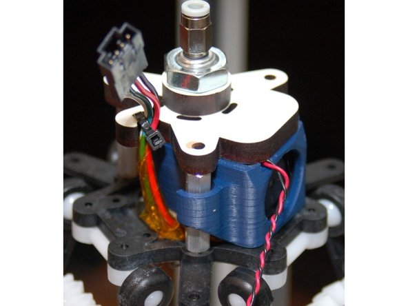 Carefully replace the PEEK fan on the hot end and rest the whole assembly on top of the stand-offs as shown in photo #1.