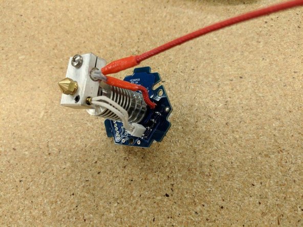 Insert the stripped lead into the position marked &quot;HEAT +&quot; as indicated by the blue circle.