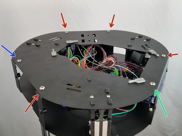 Install the remaining 4 bolts and nuts around the top plate to secure the upper plate to the upper frame as outlined by the red arrows in the picture.