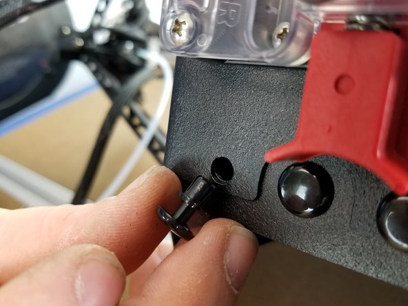 Re-install the plastic rivets by placing them in the mounting holes in the sheet metal, pushing the bottom portion in fully, then pushing the head until the rivet snaps in place flush with the sheet metal.