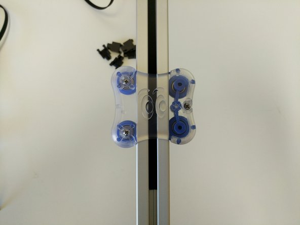 Route the belt down the opposite side of the tower. When you get to the carriage, you will need to route the belt inside the carriage between the carriage body and the TSLOT.