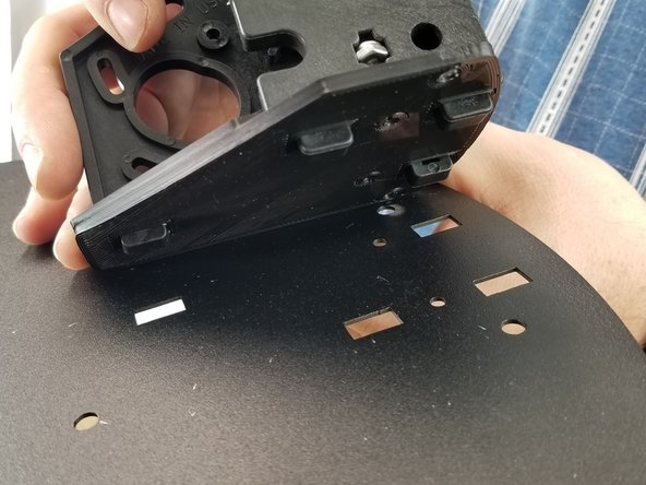 Place the shim and bracket on the sheet metal lining up the tabs from the bracket with the holes on the sheet metal.