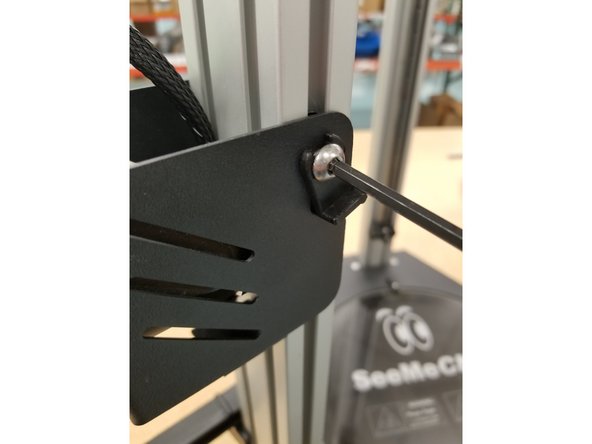 Loosen the bolts holding the extruder assembly in place.