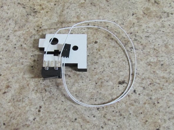 Solder the End Stop Wires (two white wires with a 3 pin connector on one end) to the outer two legs of the limit switch as shown in the image.