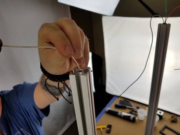 Feed the other ends of the white wires down the X tower you just installed in the previous step.