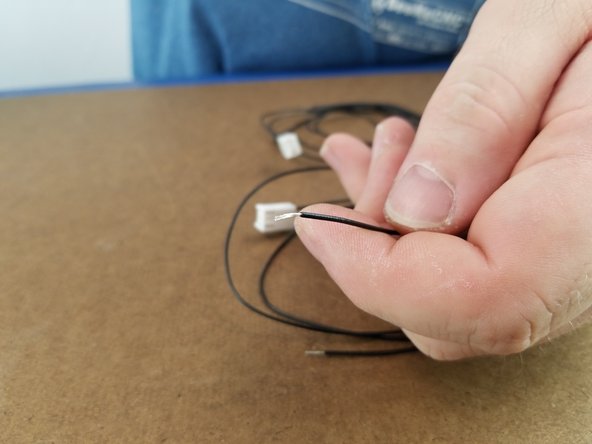 Each pair of wires will be soldered to the endstop legs that are bent out. Insert the stripped end of the wire through the hole on the leg of the endstop and bend in half to hold in place as shown in Pic 3.