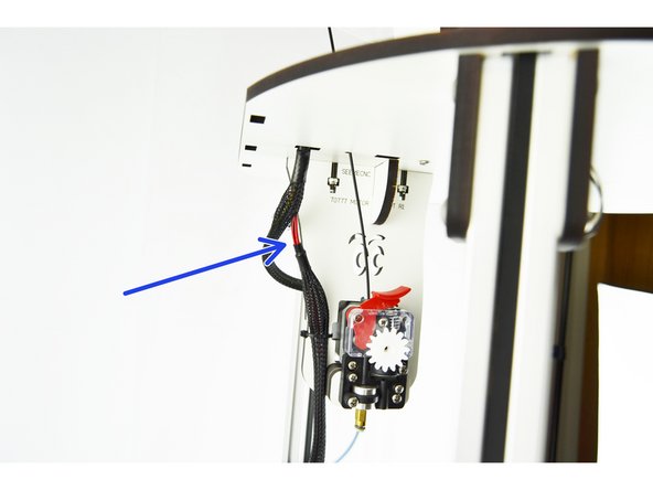 Determine the best location to cut the exitising hotend wiring/whip. There needs to be sufficient wiring left in the top of the machine to make splices with the new hot end whip. You can see in the picture where the wires for this particular Rostock v2 were cut (next to the extruder).