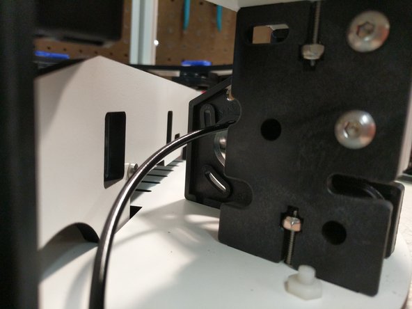 Insert the extrusion into the base top plate, and then through each set of the TSLOT hardware. You will need to have the TSLOT nuts in a vertical orientation to be accepted by the extrusion. You also may need to loosen the TSLOT nuts if you have them too tight.