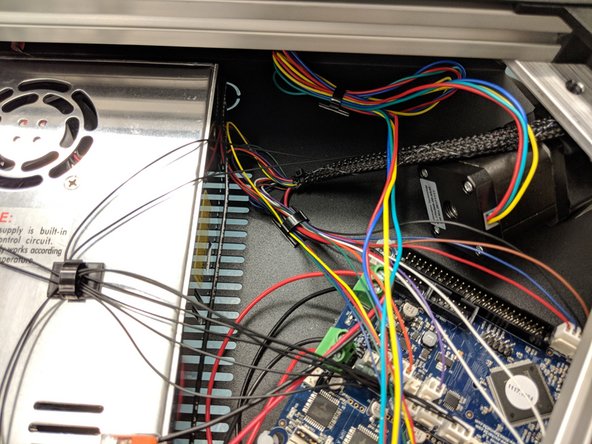 Clean up the excess wire with a zip tie. Make sure the wires aren't near where the fan from the top silver cover of the top assembly will end up, you don't want the wires getting stuck in the fan later.