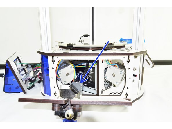 From the front of the printer, insert the new whip (8 pin connector first) through the front of the machine, over the hot end and out the side of the machine with the extruder panel removed.
