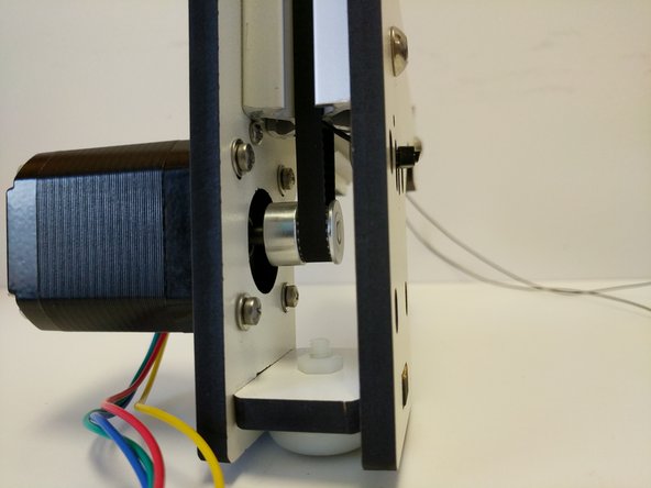 Use the body of the stepper motor to press down tensioning the belt.