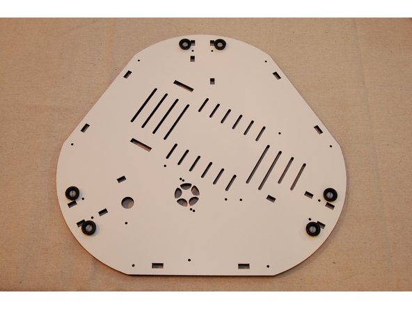 You may wish to leave the soft rubber feet off until you've completed the assembly of your Rostock MAX v3. The soft feet have a strong grip to them and can make turning the printer difficult.