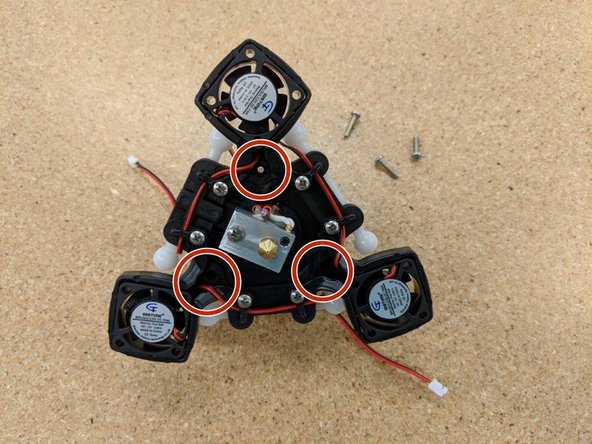 Using the three #4, 1/2&quot; screws, fix the hot end assembly to the effector platform at the locations indicated by the red circles.