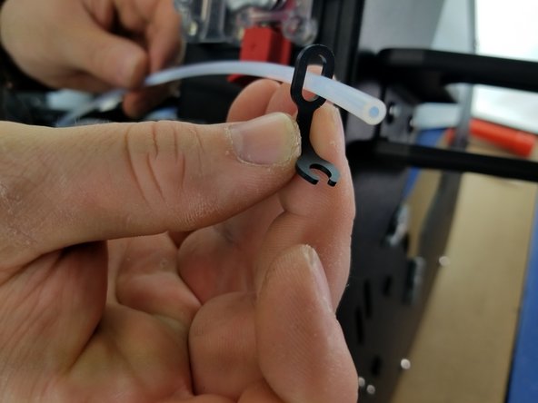 Pass the PTFE through the closed oval end of the lanyard